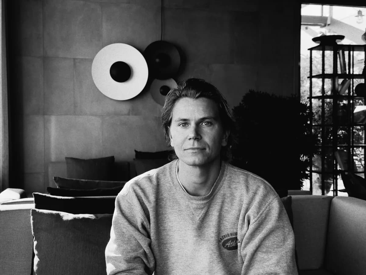 Julius, co-founder of Plant, on a sofa in the studio. Black and white.