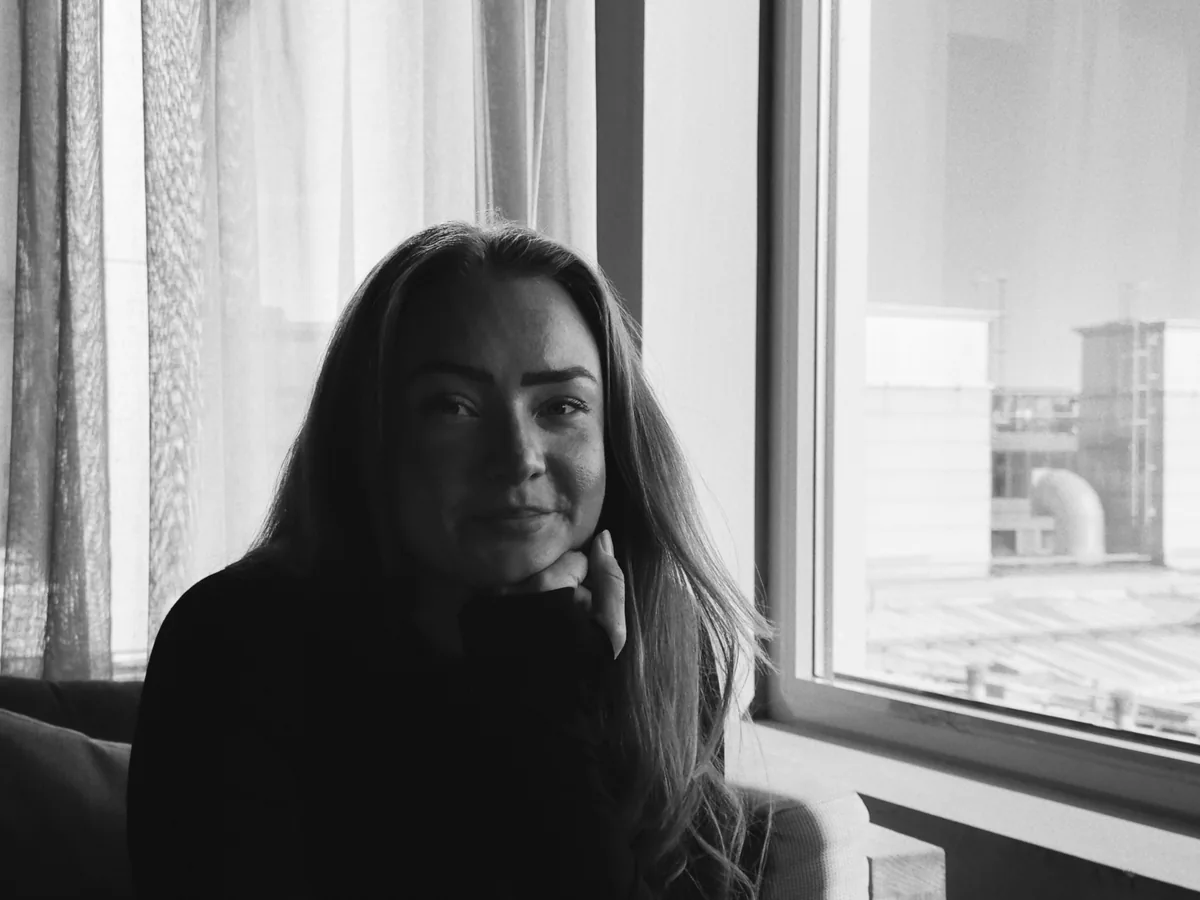 Line, co-founder of Plant, by a window in the studio. Black and white.