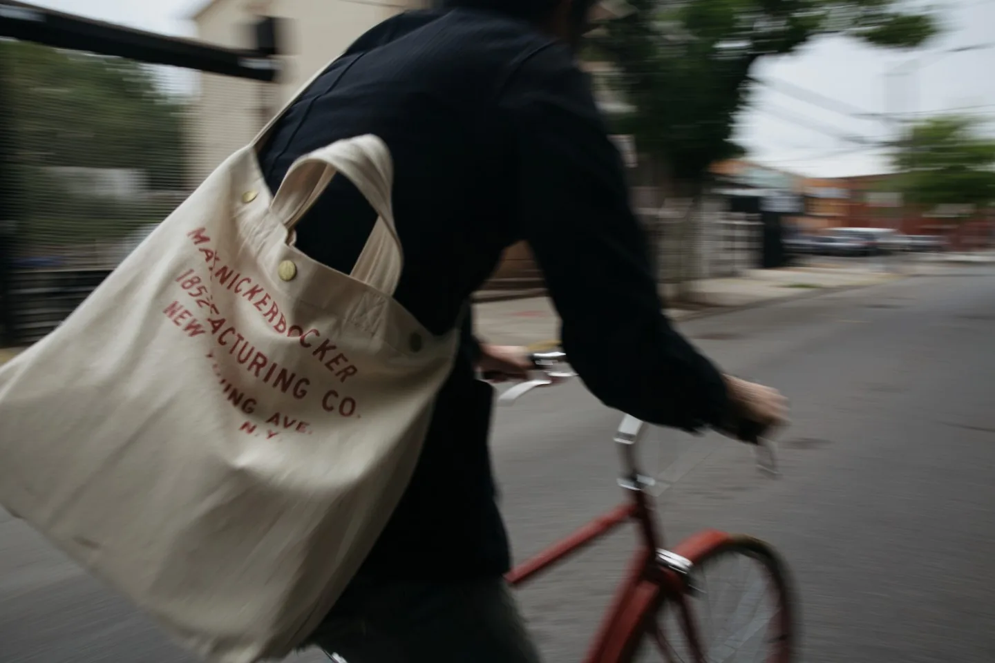 A person riding a bicycle, blurred by movement.